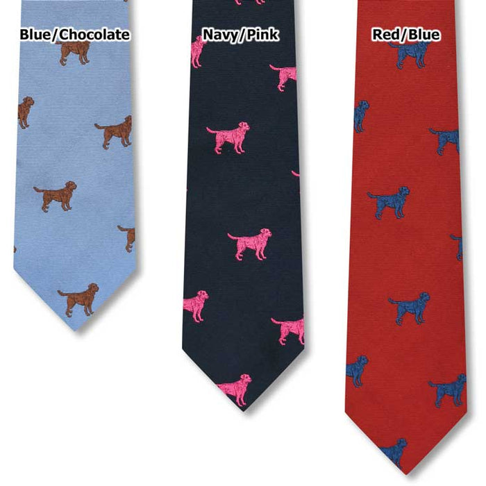 Handcrafted silk ties in blue, navy, and red featuring repeating Labrador retriever dog patterns in contrasting colors.