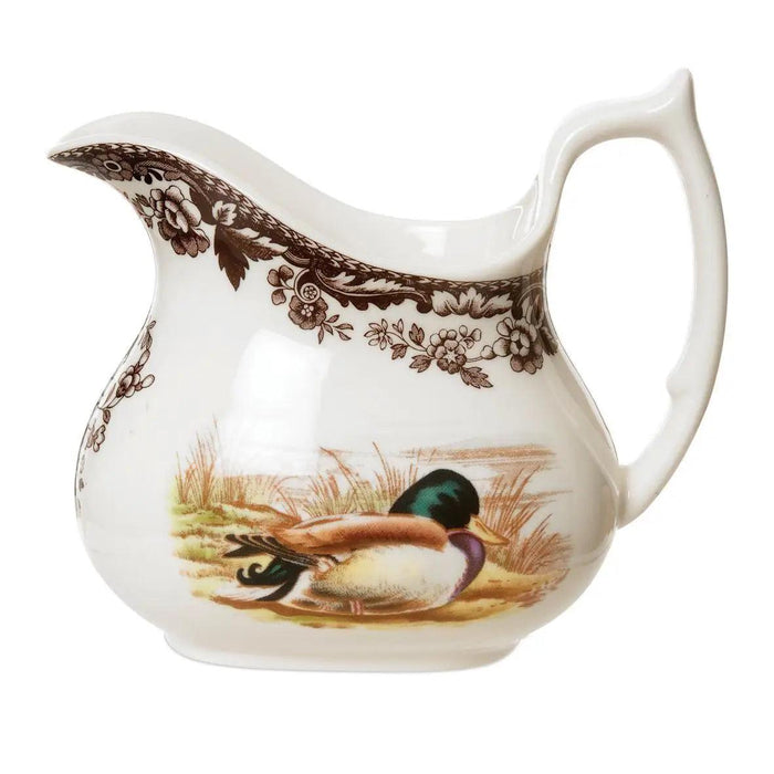 Spode Woodland earthenware creamer featuring a mallard duck motif and classic brown floral border.