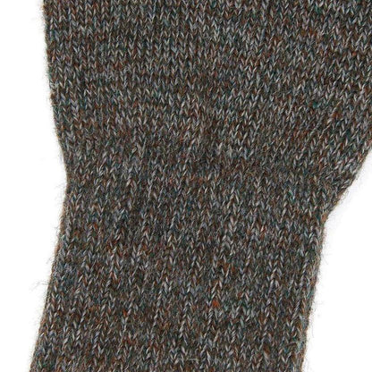 Close-up of brown and grey marled lambswool fingerless gloves with a textured 7-gauge knit.