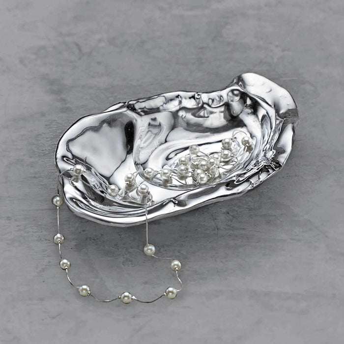 Handcrafted polished aluminum oyster bowl with a lustrous silver finish and organic, shell-inspired design.