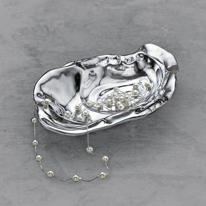 Handcrafted polished aluminum oyster bowl with a lustrous silver finish and organic, shell-inspired design.