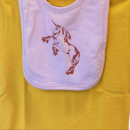 Yellow baby shirt with pink bib featuring a bright red unicorn on roller skates.