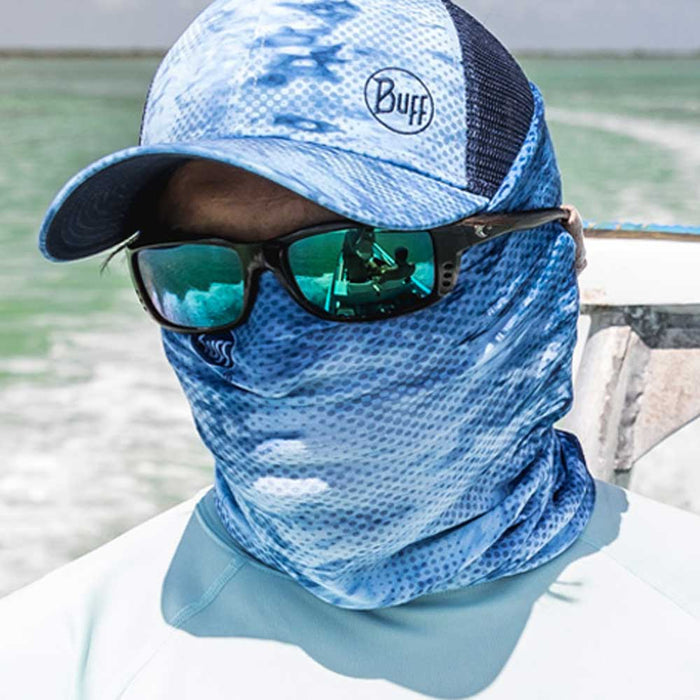 Angler wearing a blue patterned Buff CoolNet UV+ neck gaiter and matching cap for sun protection on the water.