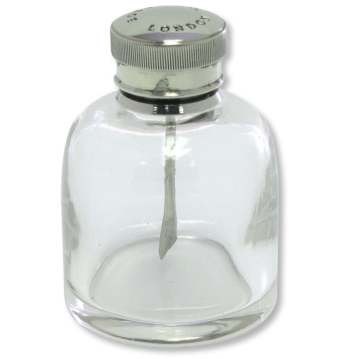 Round clear glass oil bottle with a nickel-plated brass lid and internal blade applicator for firearm maintenance.