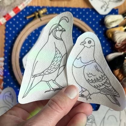 Two embroidery transfers with odd looking birds: pigeon and quail.
