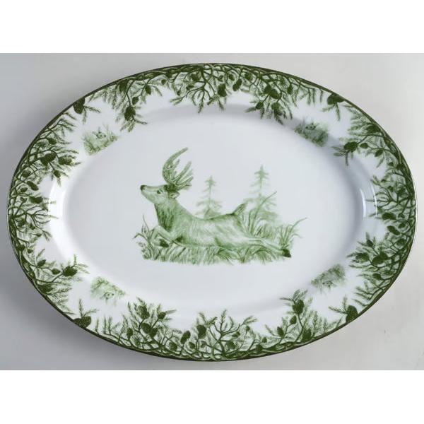 Large 18-inch oval porcelain platter featuring a green buck and forest scene with a pine branch border.