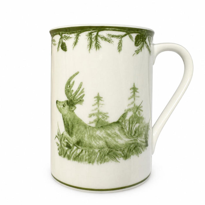 White porcelain mug featuring a green deer and forest illustration with pine branch detailing.