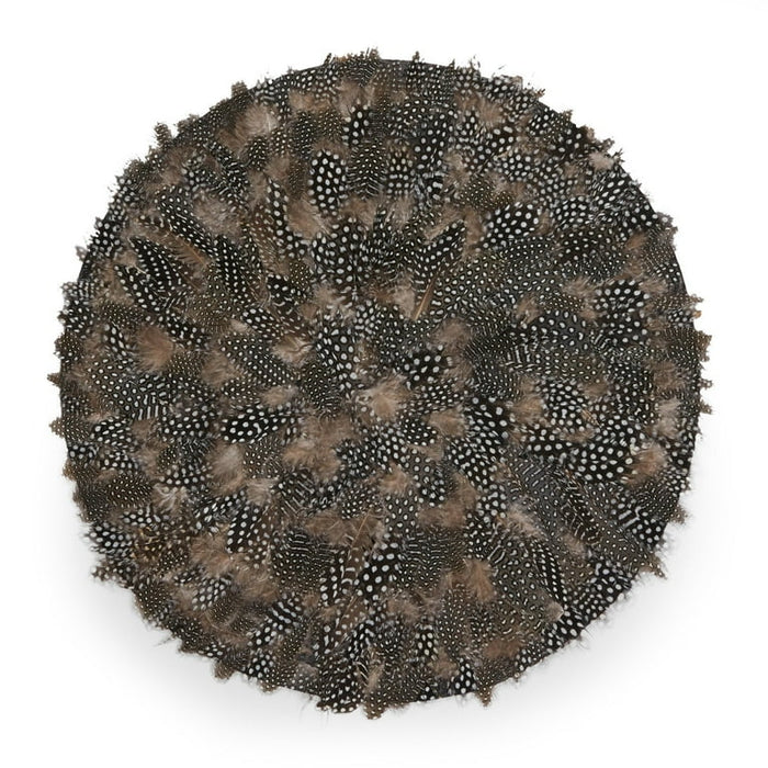 17-inch round placemat handcrafted from natural black, white, and brown speckled guinea feathers with textured detail.