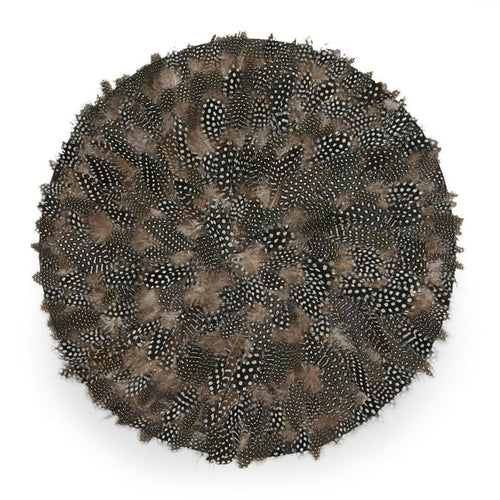 17-inch round placemat handcrafted from natural black, white, and brown speckled guinea feathers with textured detail.