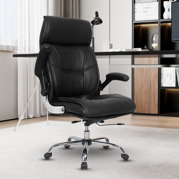 Black office chair in a modern office setting with a desk and shelves.