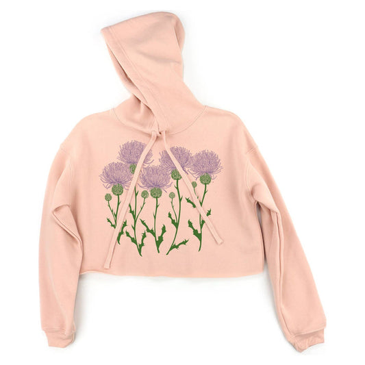 Apricot hoodie with purple thistle design on a white background.