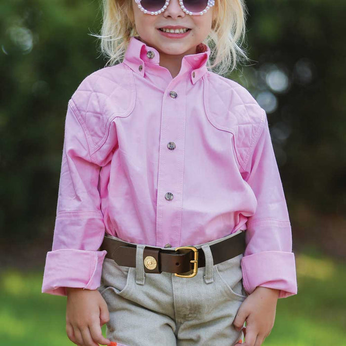 Child wearing a pink 100% cotton long-sleeve shooting shirt with quilted shoulder patches and a button-down collar.