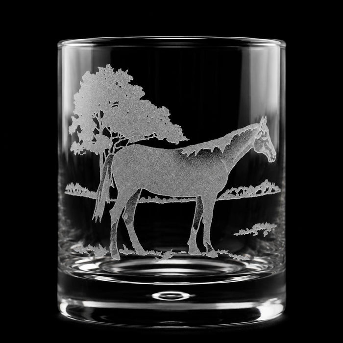 11oz crystal old fashioned glass featuring a detailed sand-etched horse standing under a tree against a black background.