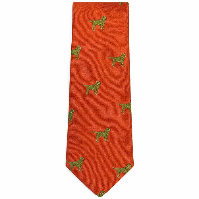 Handcrafted burnt orange silk tie featuring a repeating pattern of small green Labrador retriever dogs.