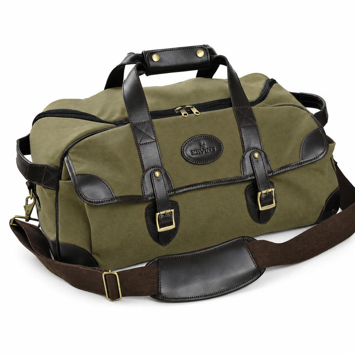Olive canvas duffel bag with mahogany leather trim, brass hardware, and a padded shoulder strap on a white background.