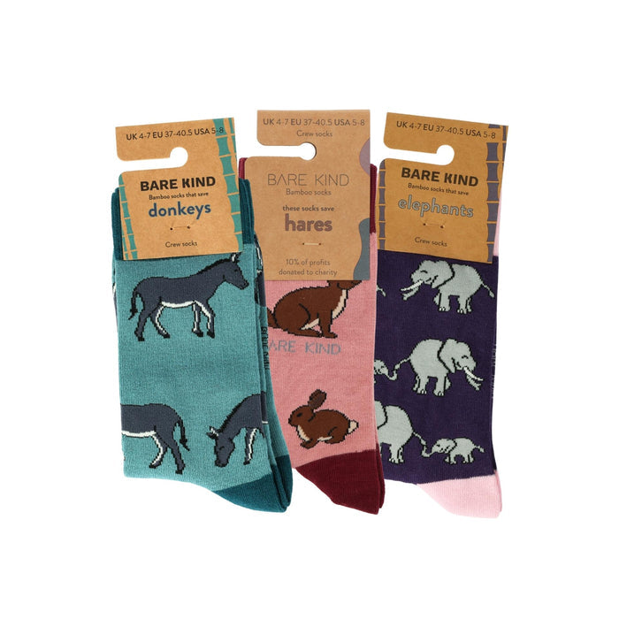 Three pairs of animal-themed socks with packaging on a white background