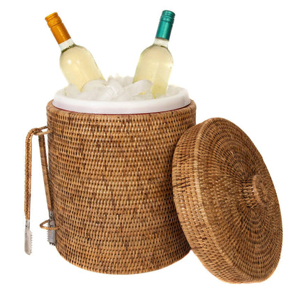 Handwoven Burmese rattan ice bucket with matching tongs, filled with ice and two wine bottles, isolated on white.