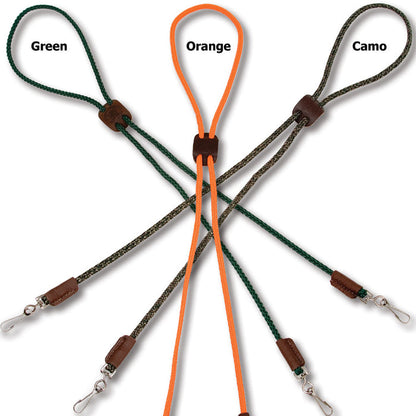 Mendota double whistle lanyards in green, orange, and camo with braided polypropylene cord, leather slides, and metal clips.