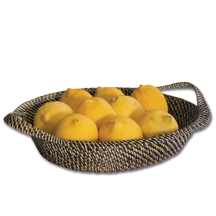 Handwoven oval wicker basket with handles filled with fresh yellow lemons, featuring a durable, tight-weave vine finish.