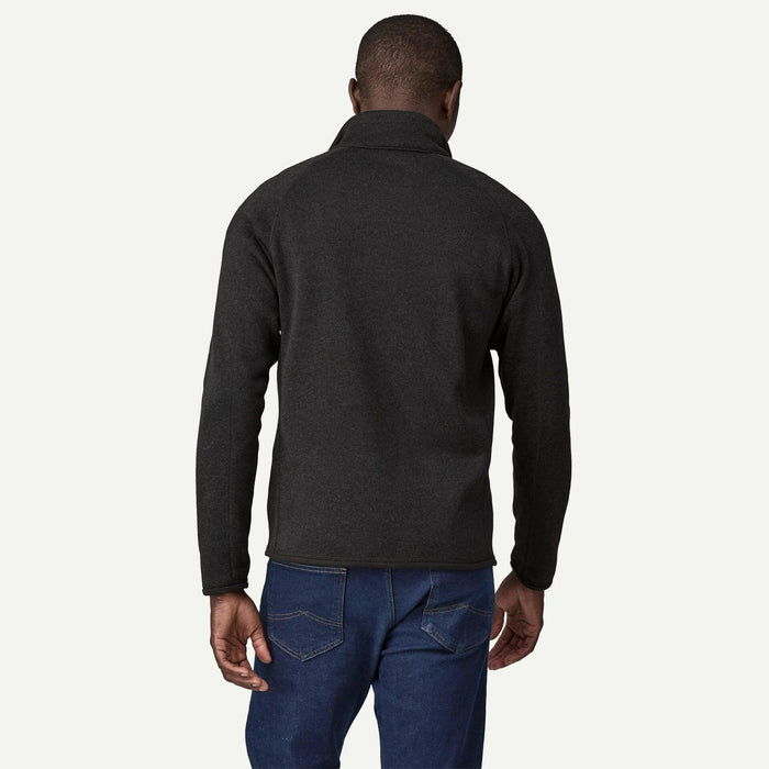 Back view of a man wearing a charcoal grey Patagonia Better Sweater fleece jacket with a stand-up collar and raglan sleeves.