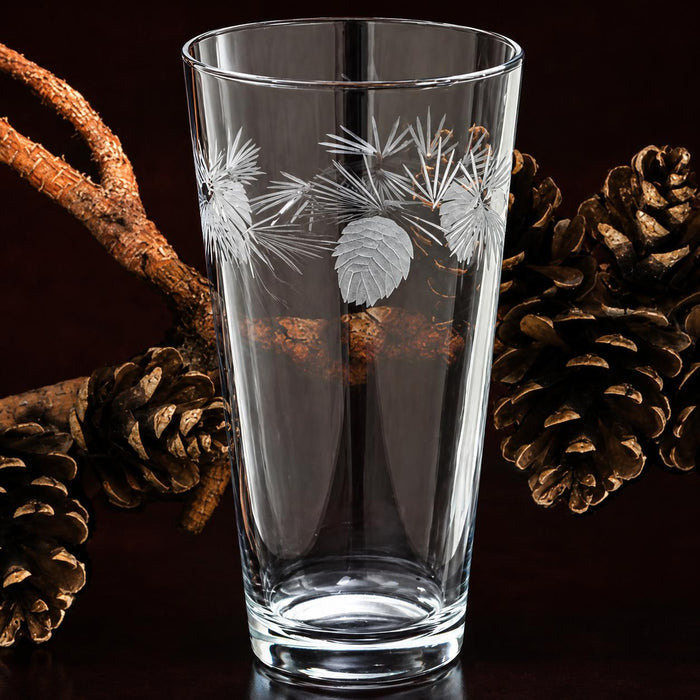 16 oz clear glass iced tea tumbler featuring etched frosted pinecone and pine needle designs.