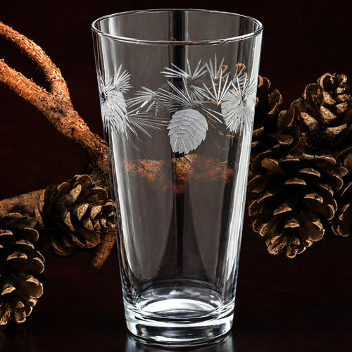 16 oz clear glass iced tea tumbler featuring etched frosted pinecone and pine needle designs.