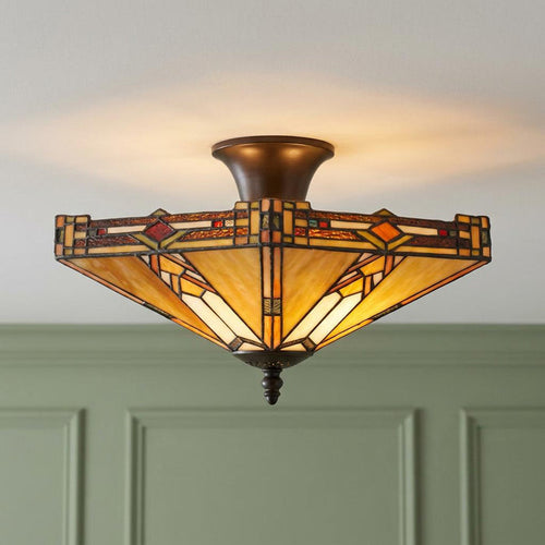 Prairie style Tiffany semi-flush ceiling light with a geometric amber glass shade on a white ceiling.