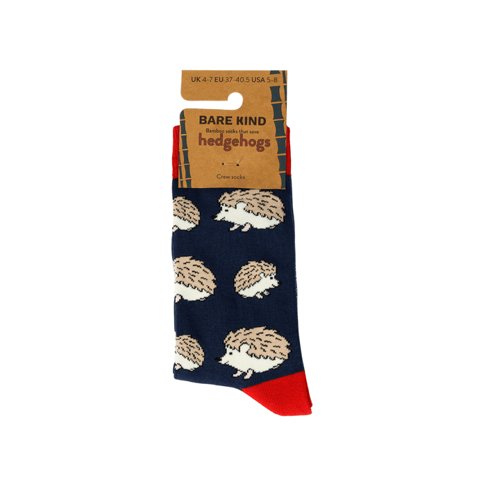 Navy sock with hedgehog pattern and red toes, displayed with packaging on a white background