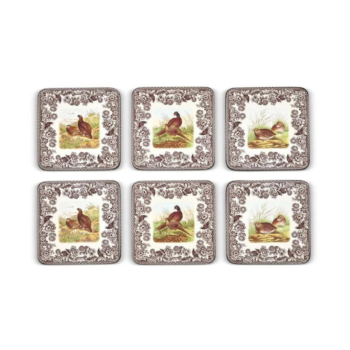 Set of six square Spode Woodland hardboard coasters featuring quail, grouse, and pheasant designs with brown floral borders.