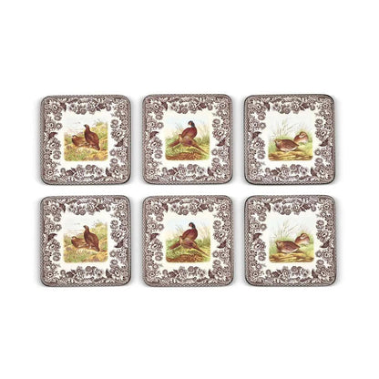 Set of six square Spode Woodland hardboard coasters featuring quail, grouse, and pheasant designs with brown floral borders.