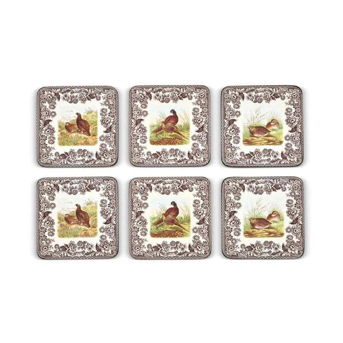 Set of six square Spode Woodland hardboard coasters featuring quail, grouse, and pheasant designs with brown floral borders.