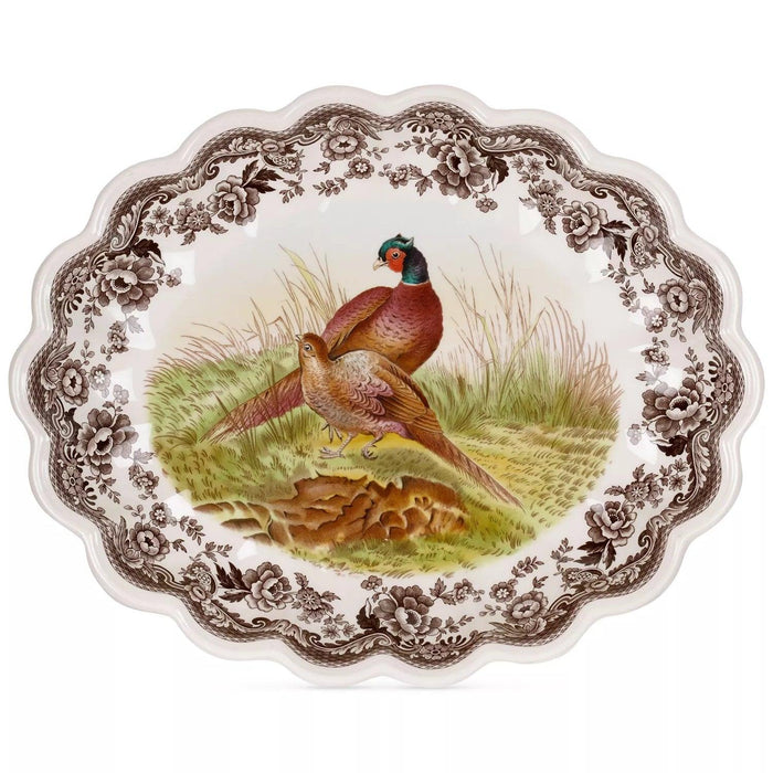 Spode Woodland 14.5-inch oval fluted earthenware dish featuring a pheasant illustration and brown floral border.