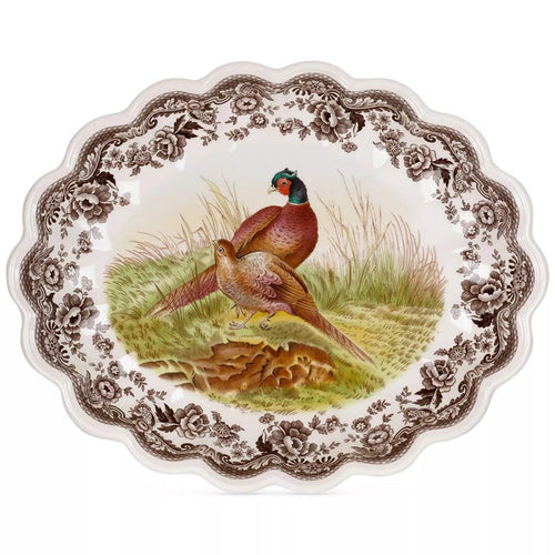 Spode Woodland 14.5-inch oval fluted earthenware dish featuring a pheasant illustration and brown floral border.