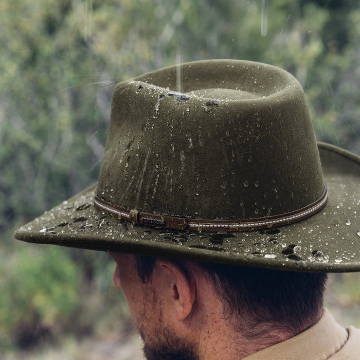 Olive green Stetson Gallatin wool hat with water-resistant finish and leather band worn in the rain.