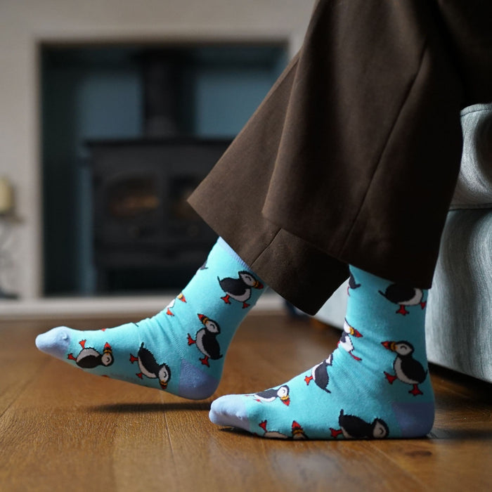 model wearing blue puffin socks