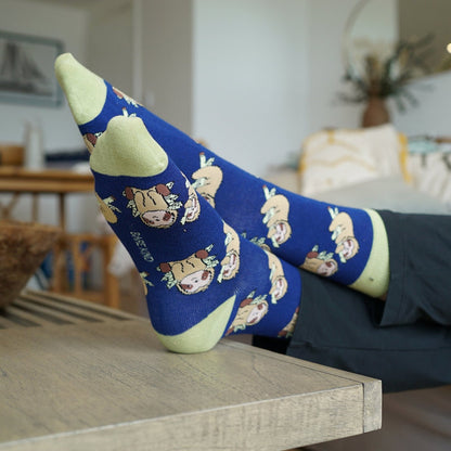 blue sloth bamboo socks on a wooden table in a living room setting