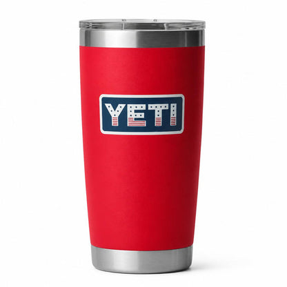 Red 20 oz YETI Rambler tumbler with stainless steel base and a patriotic American flag-themed YETI logo.